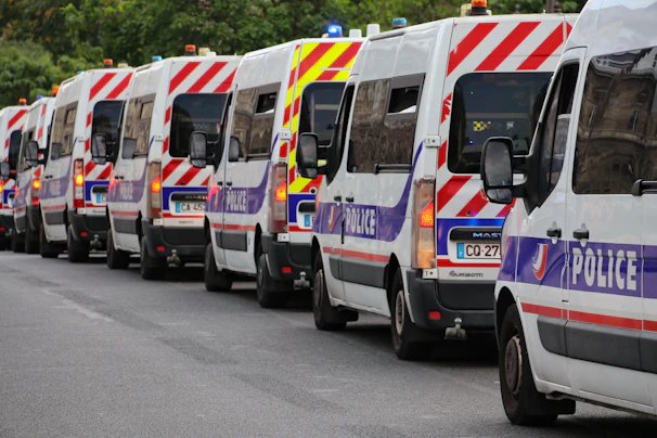 A line of french police vans on a street