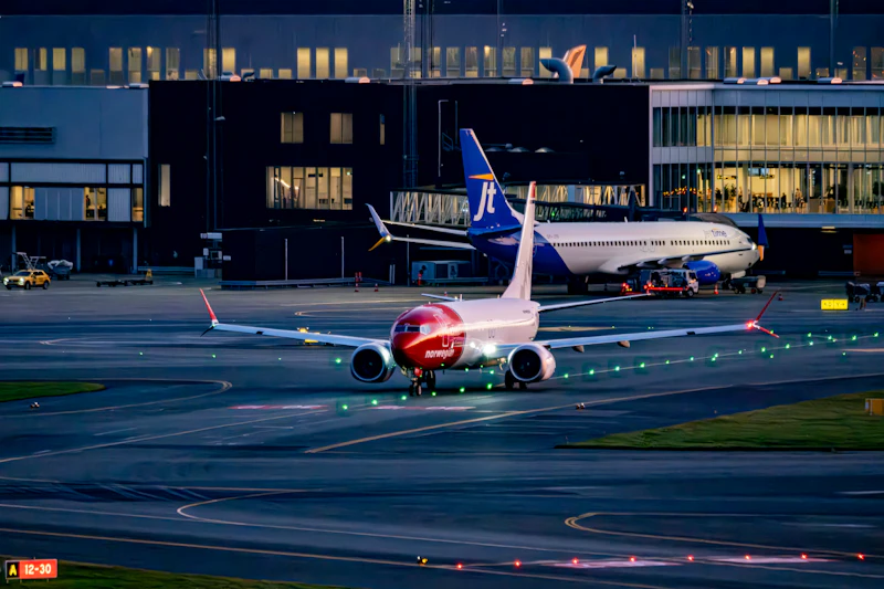 Airliner taxiing on the tarmac at dusk