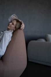 Woman relaxing in a modern chair with hand in hair