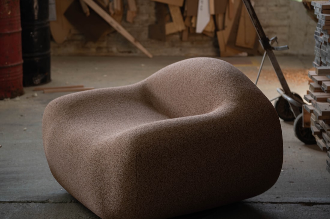 Modern design studio with fabric swatches and furniture sketches on a large table