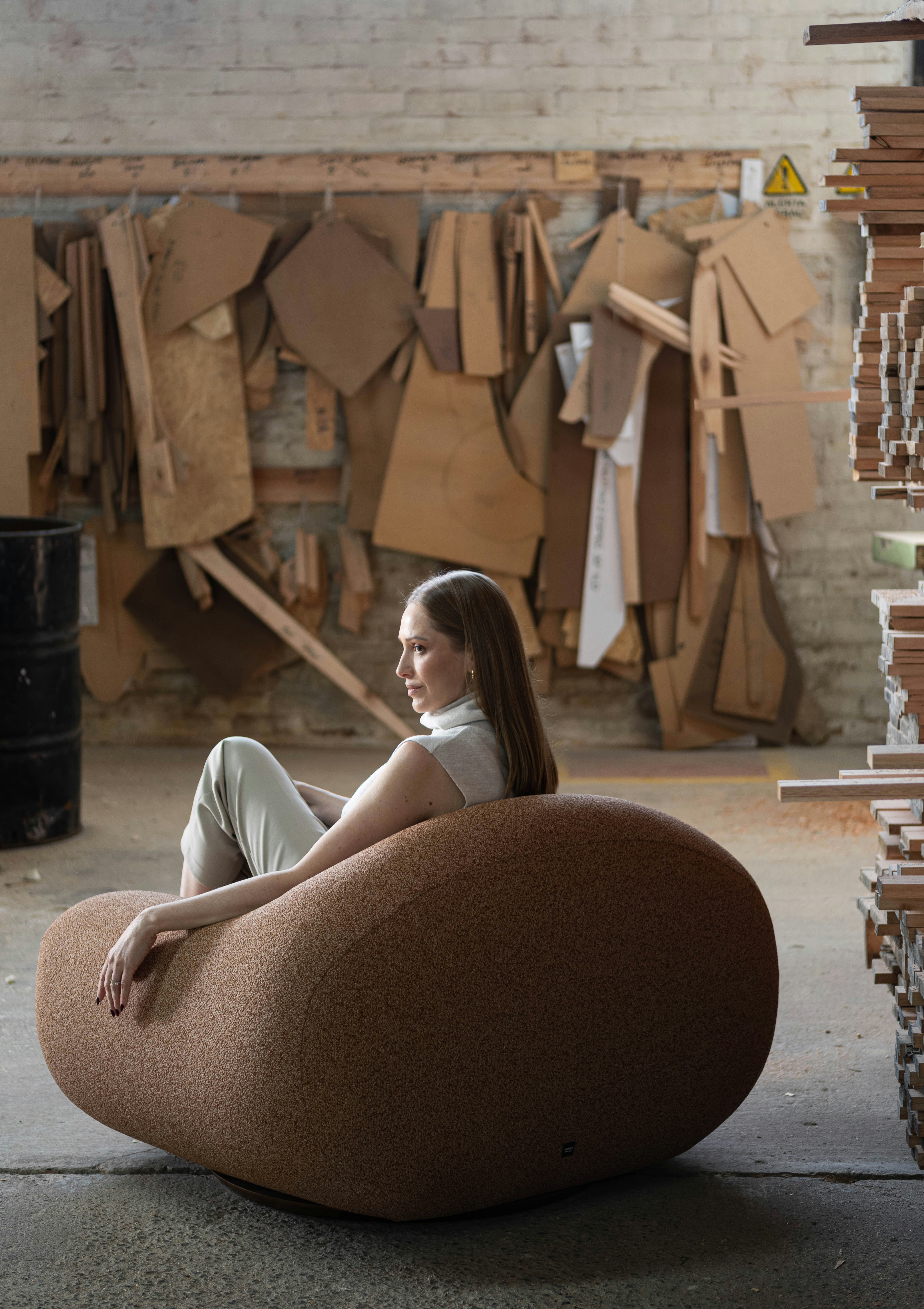 Woman sitting in a large, textured armchair.