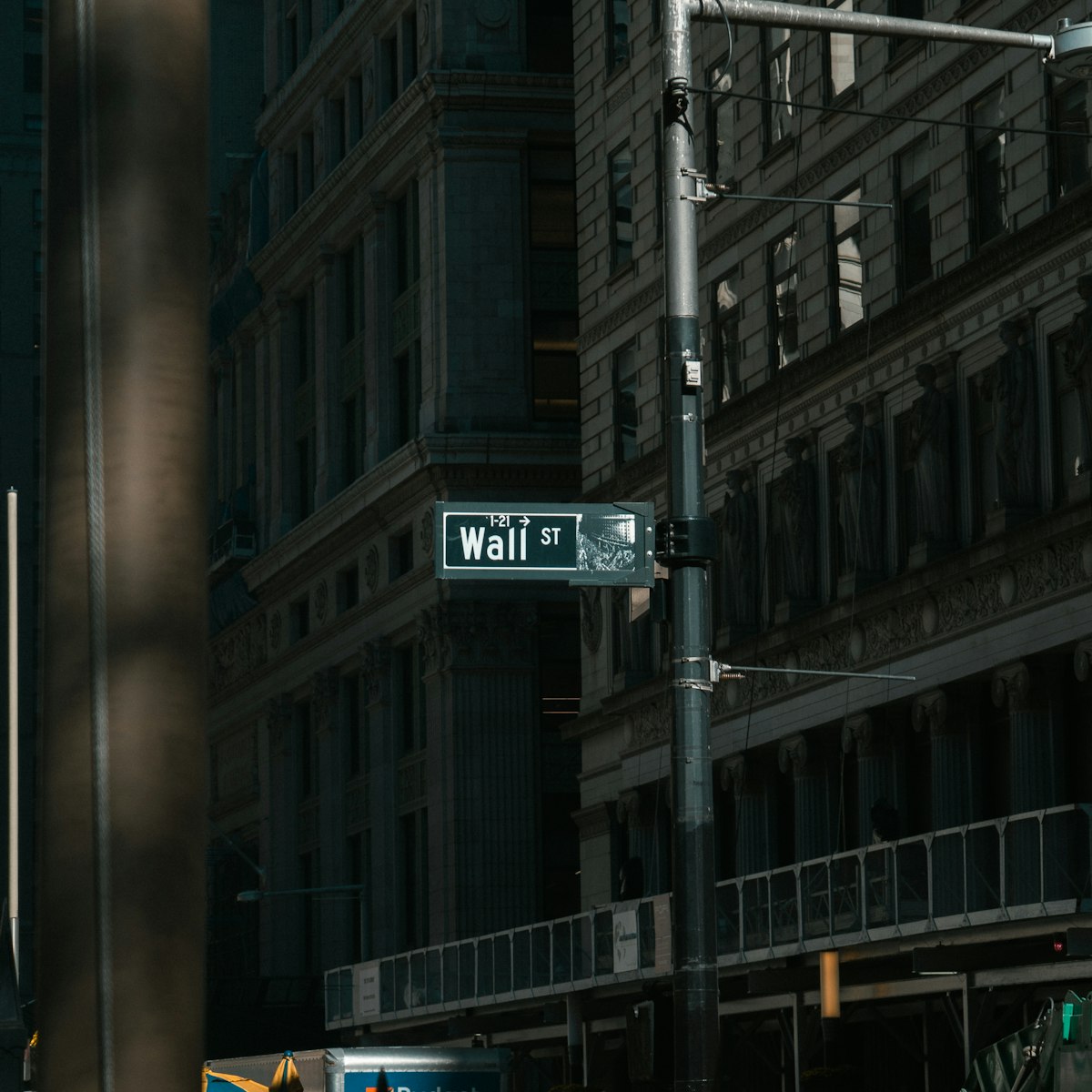 Wall Street sign on a building facade in New York City's financial district