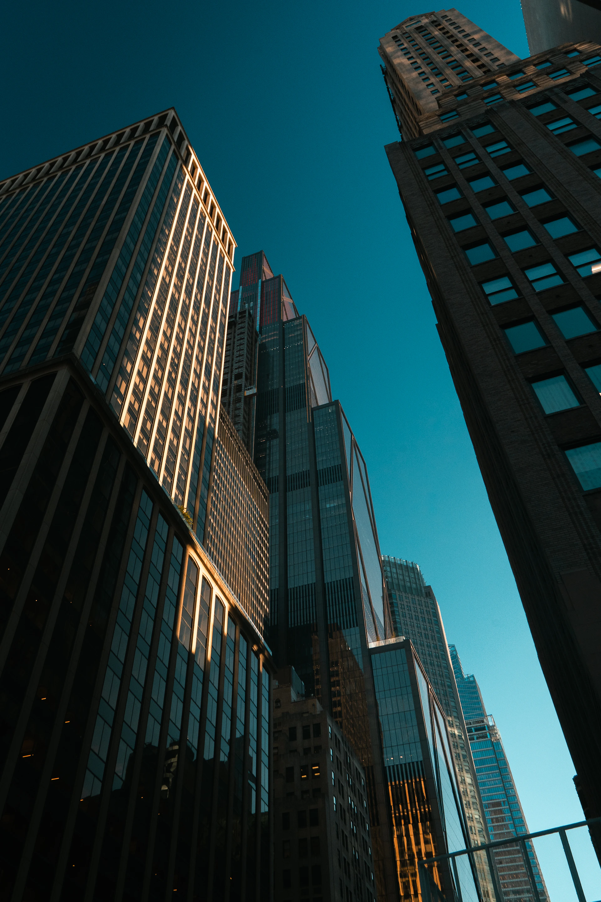 Modern skyscrapers reaching towards a clear blue sky
