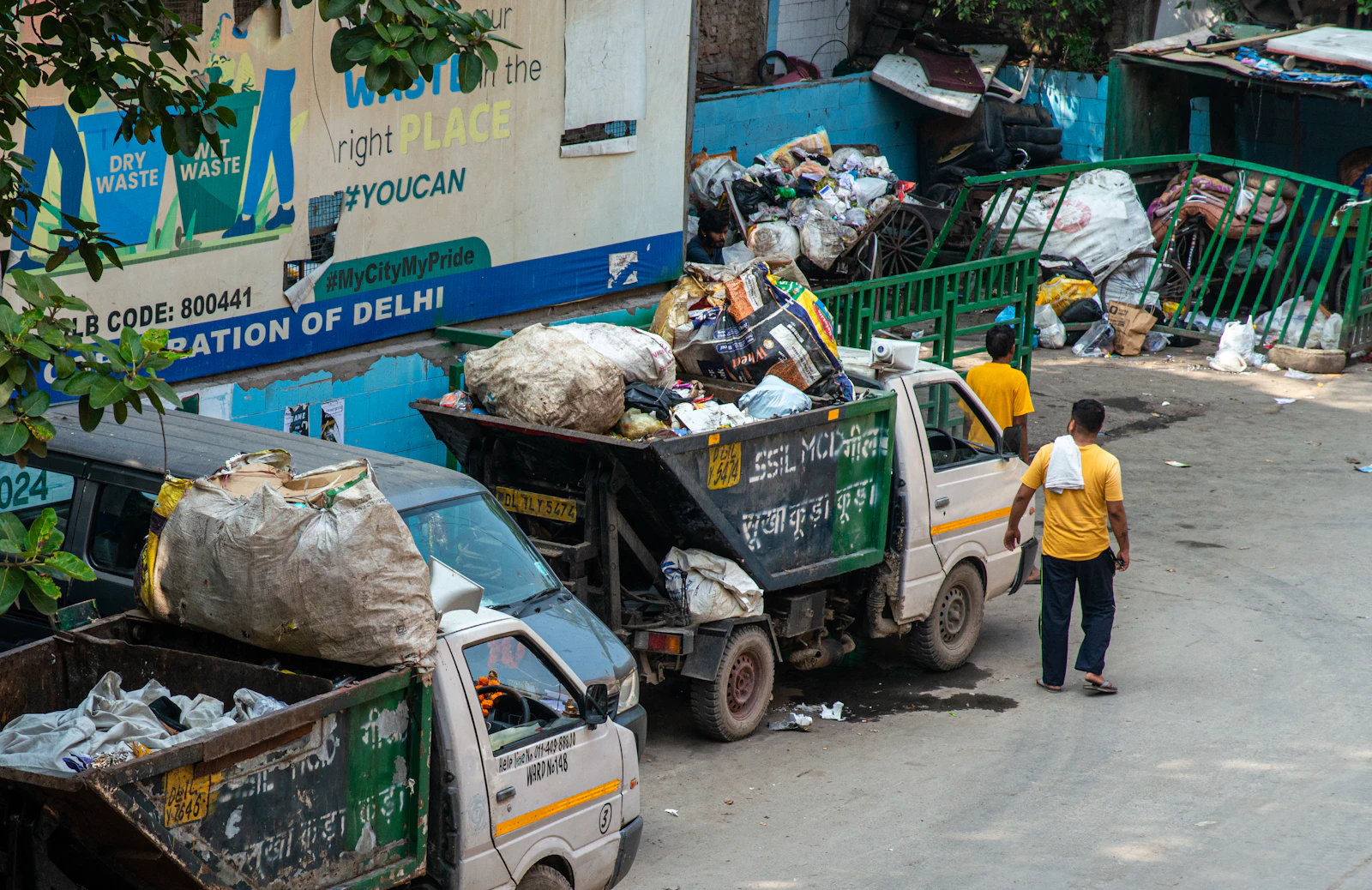 Crew members loading waste into a collection truck