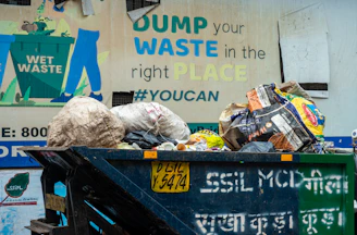 Overflowing dumpster with trash and a sign
