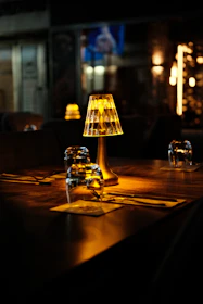 Table setting with illuminated lamp in dim restaurant