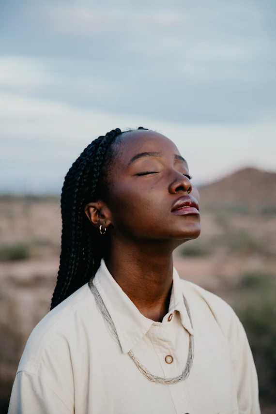 Young woman with braided hair in desert landscape