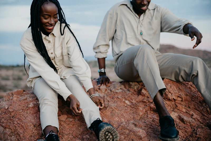 couple sitting together on a scenic outdoor rock