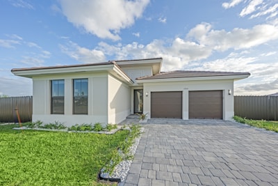 Modern house with a paved driveway and garage.