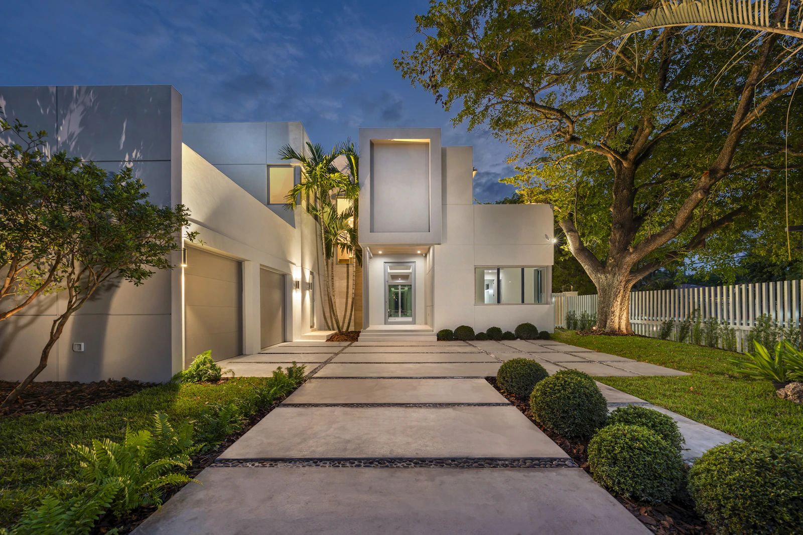 Illuminated modern luxury villa exterior at dusk, an example of architecture design in Mumbai