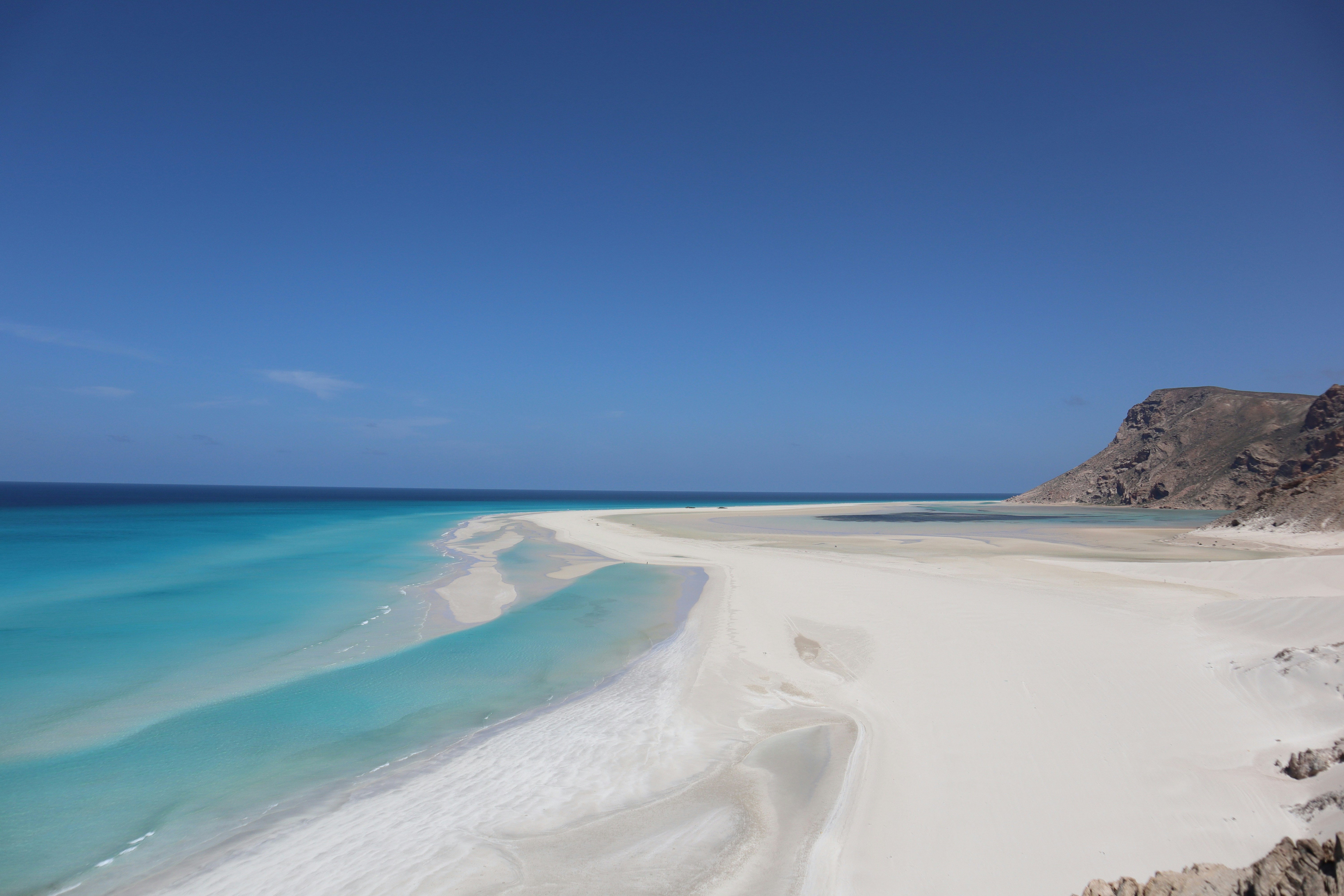 Pristine white beach and turquoise lagoon on a remote island