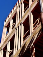 Wooden building frame against a blue sky