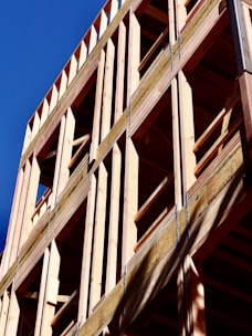 Wooden building frame against a blue sky