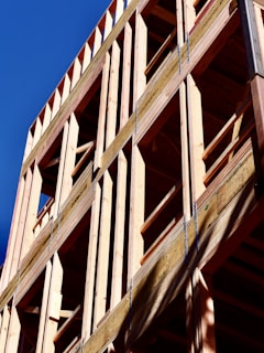 Wooden building frame against a blue sky