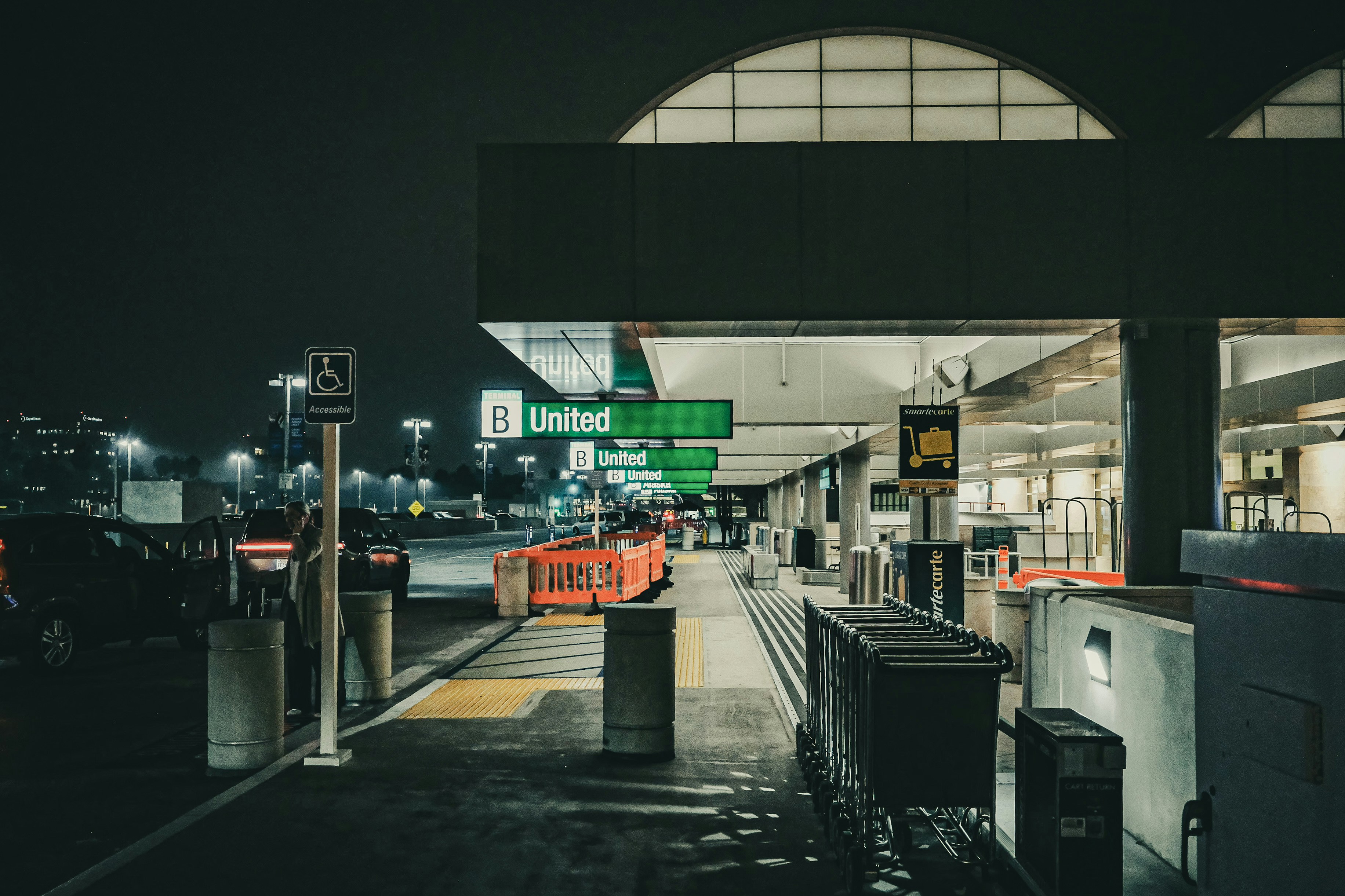 Airport terminal entrance at night with united signage