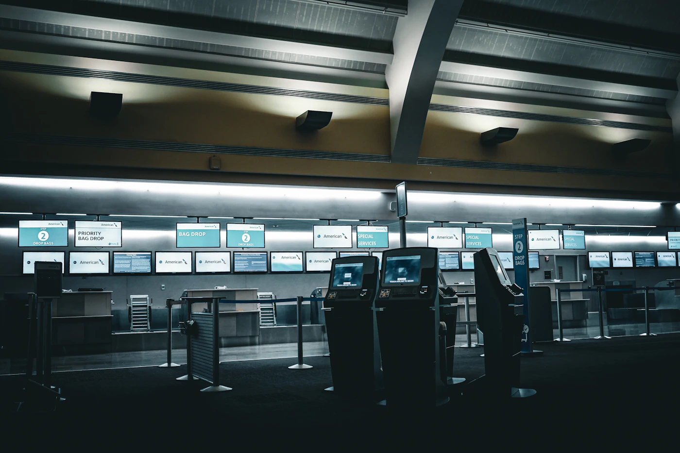 Airport check-in counters with glowing screens