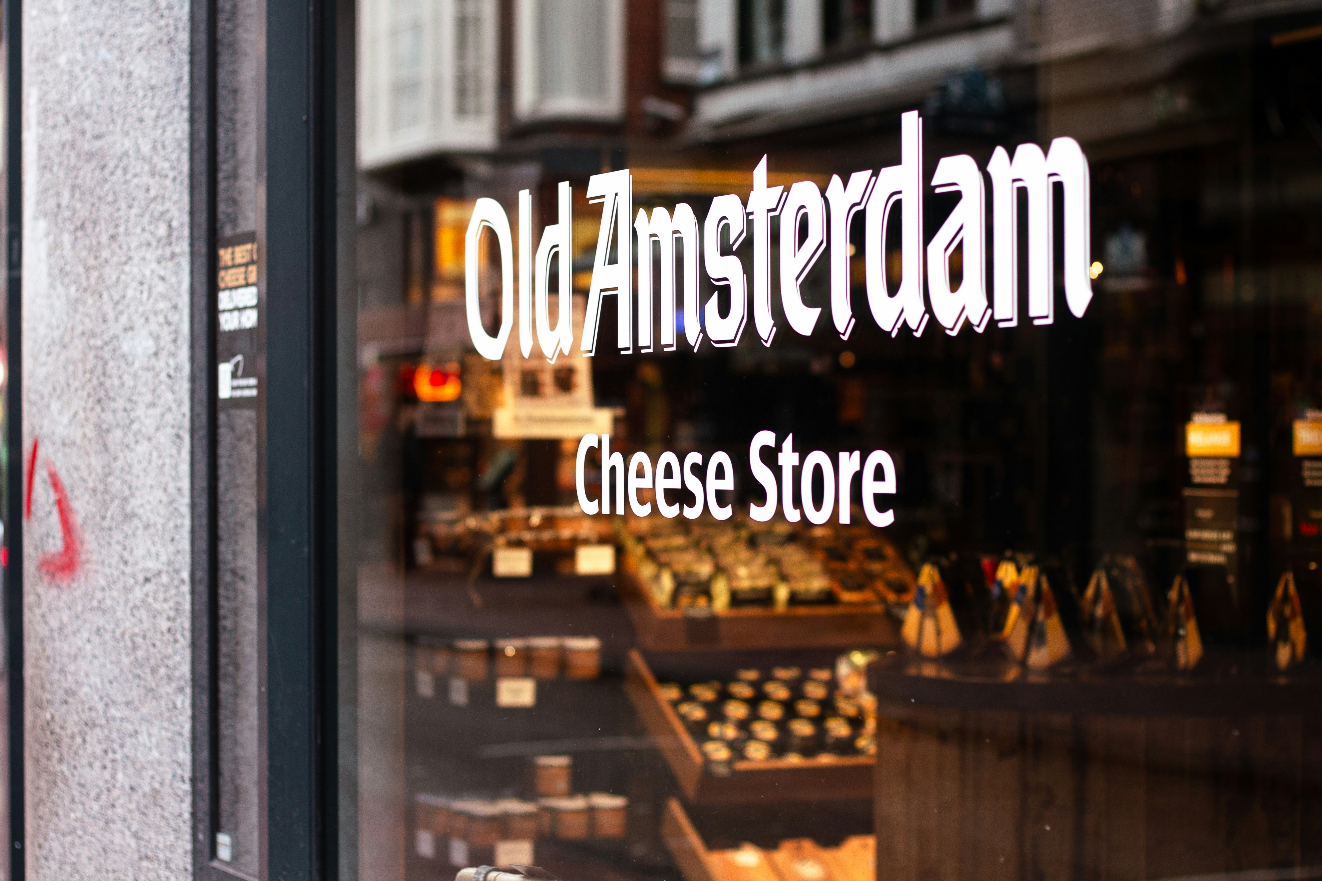Old amsterdam cheese store storefront with products displayed.