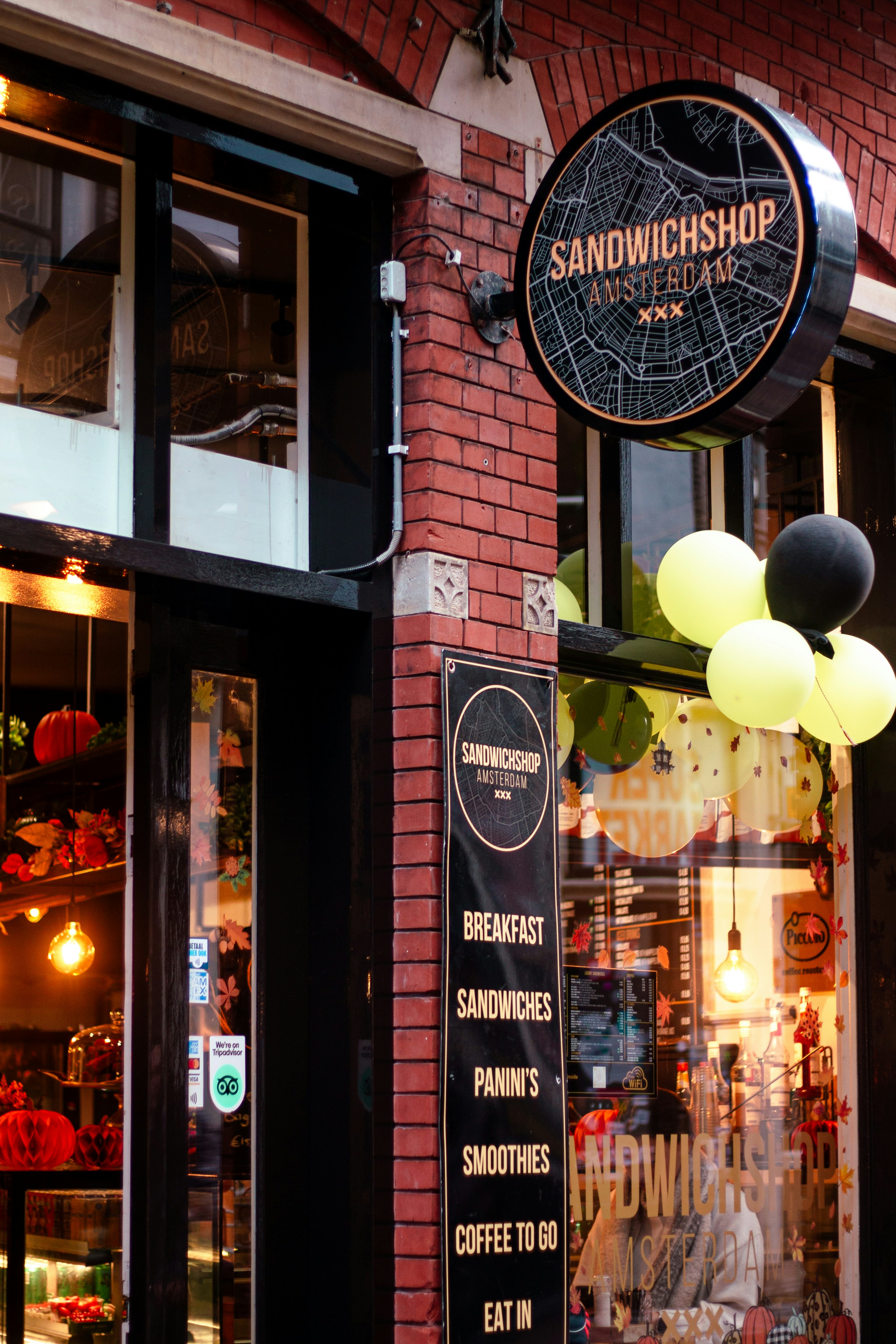 Sandwich shop exterior with balloons and menu