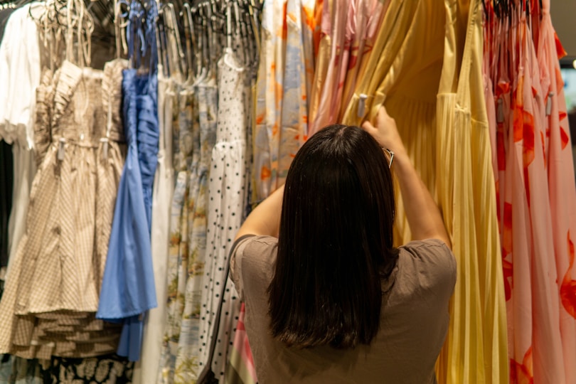 Woman browsing dresses on a clothing rack