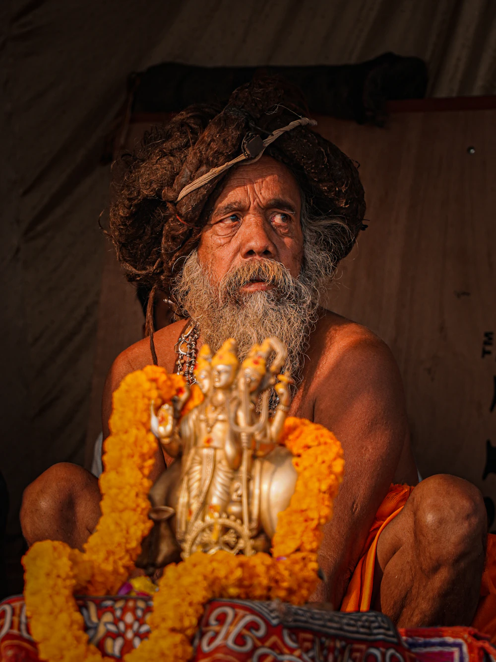 A holy man adorned with marigolds