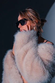 Woman in sunglasses and fur coat