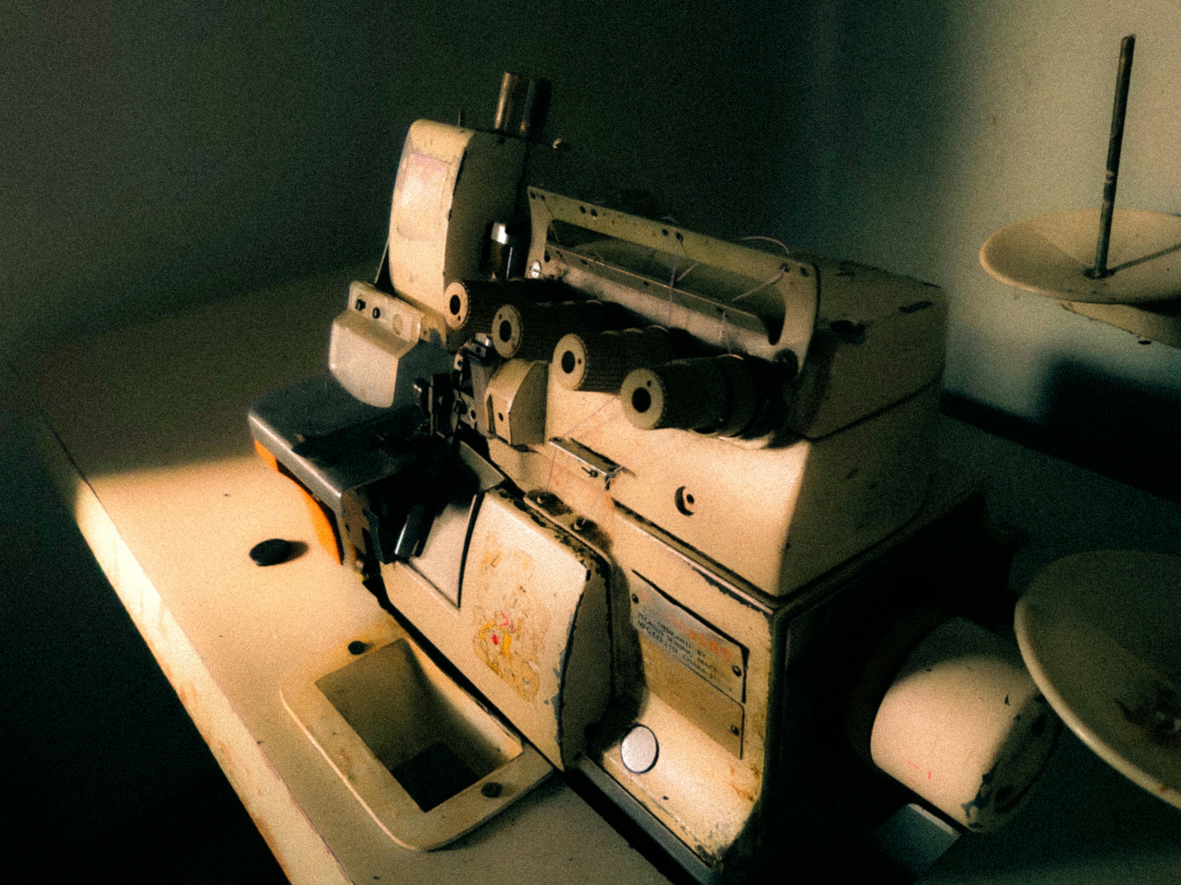 Vintage serger sewing machine on wooden table