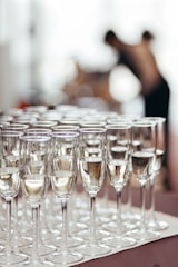Rows of champagne glasses filled with bubbly liquid.