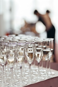 Rows of champagne glasses filled with bubbly liquid.