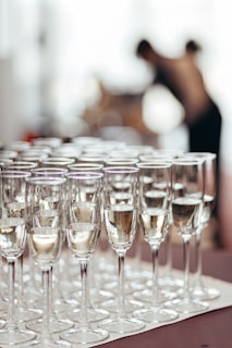 Rows of champagne glasses filled with bubbly liquid.