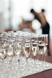 Rows of champagne glasses filled with bubbly liquid.