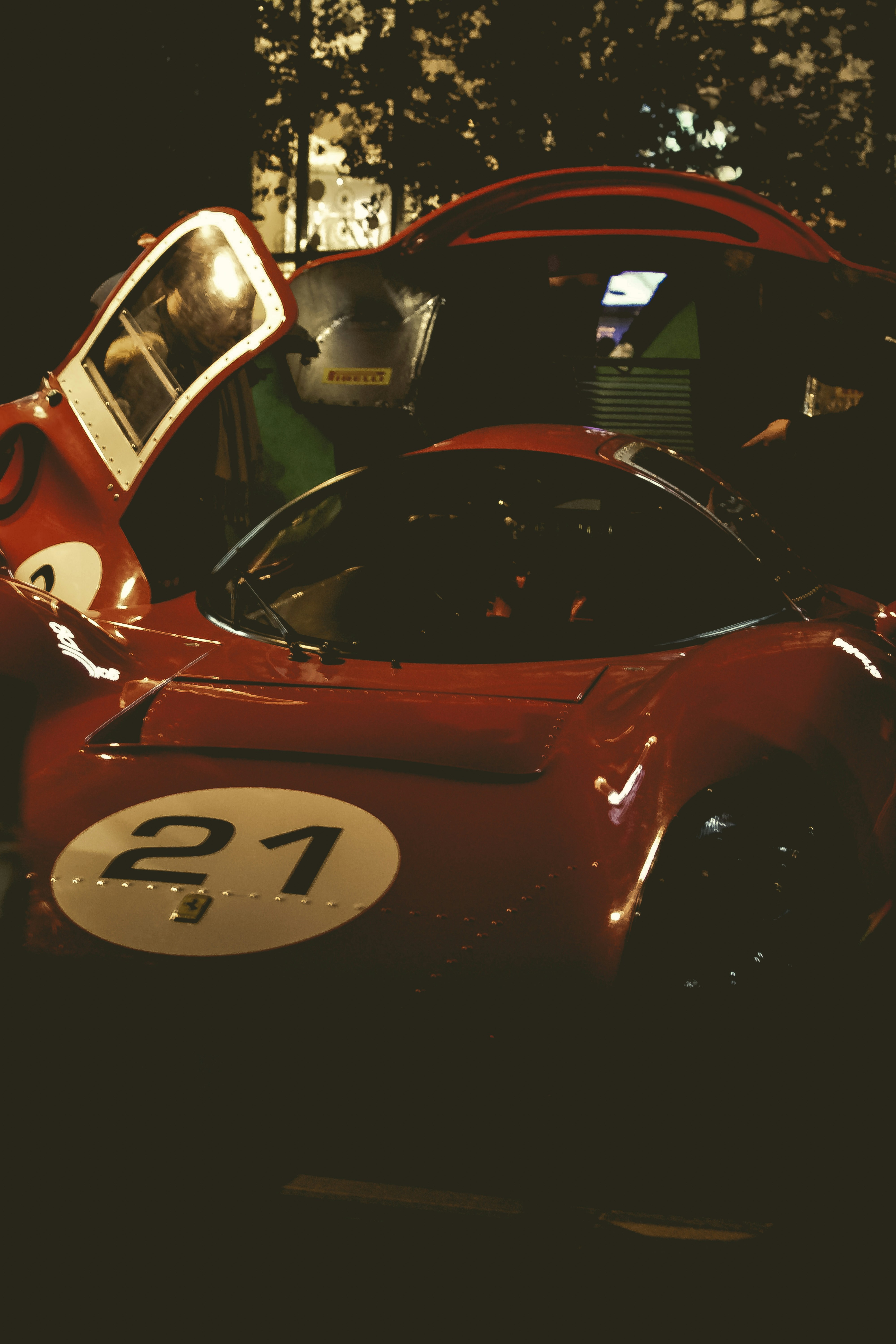 Red race car with number 21 at night.