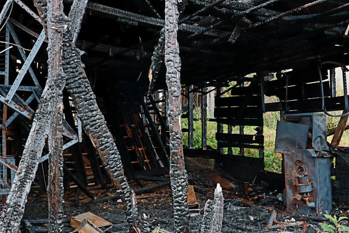 Charred beams inside a fire-damaged commercial structure