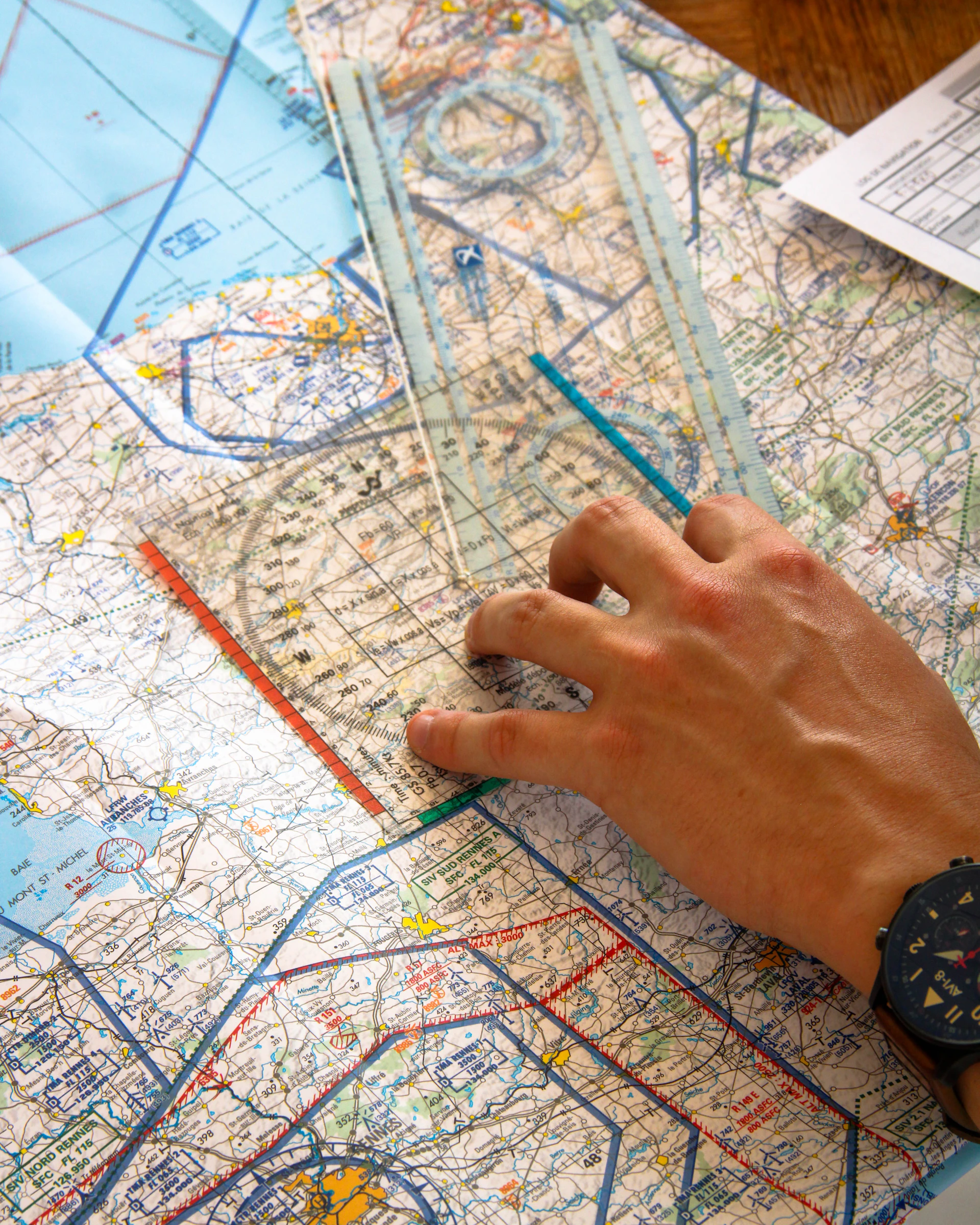 Hand using ruler on aviation chart