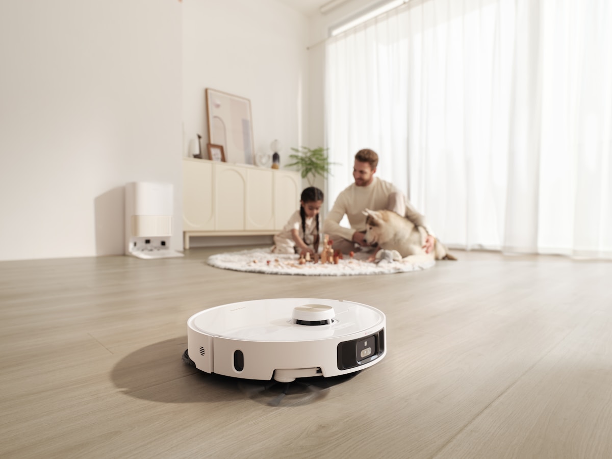 Robot vacuum cleans floor while family relaxes