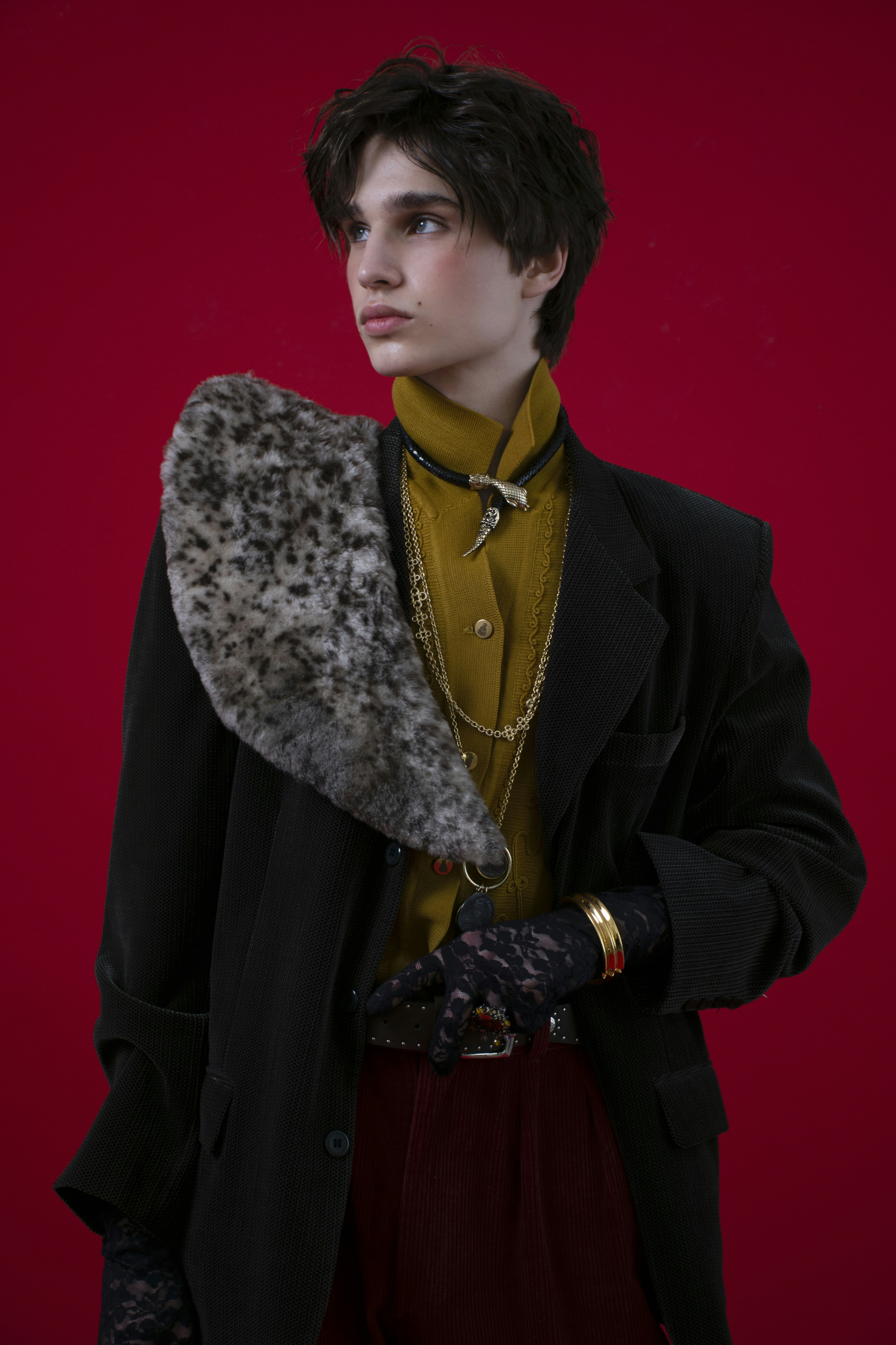 A person in stylish vintage clothing against red background