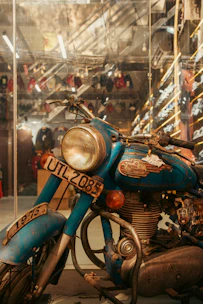 A vintage blue motorcycle with a license plate.