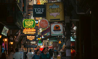 Busy street with many signs and people walking.
