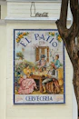 Tiled mural of people dining at el patio cerveceria.