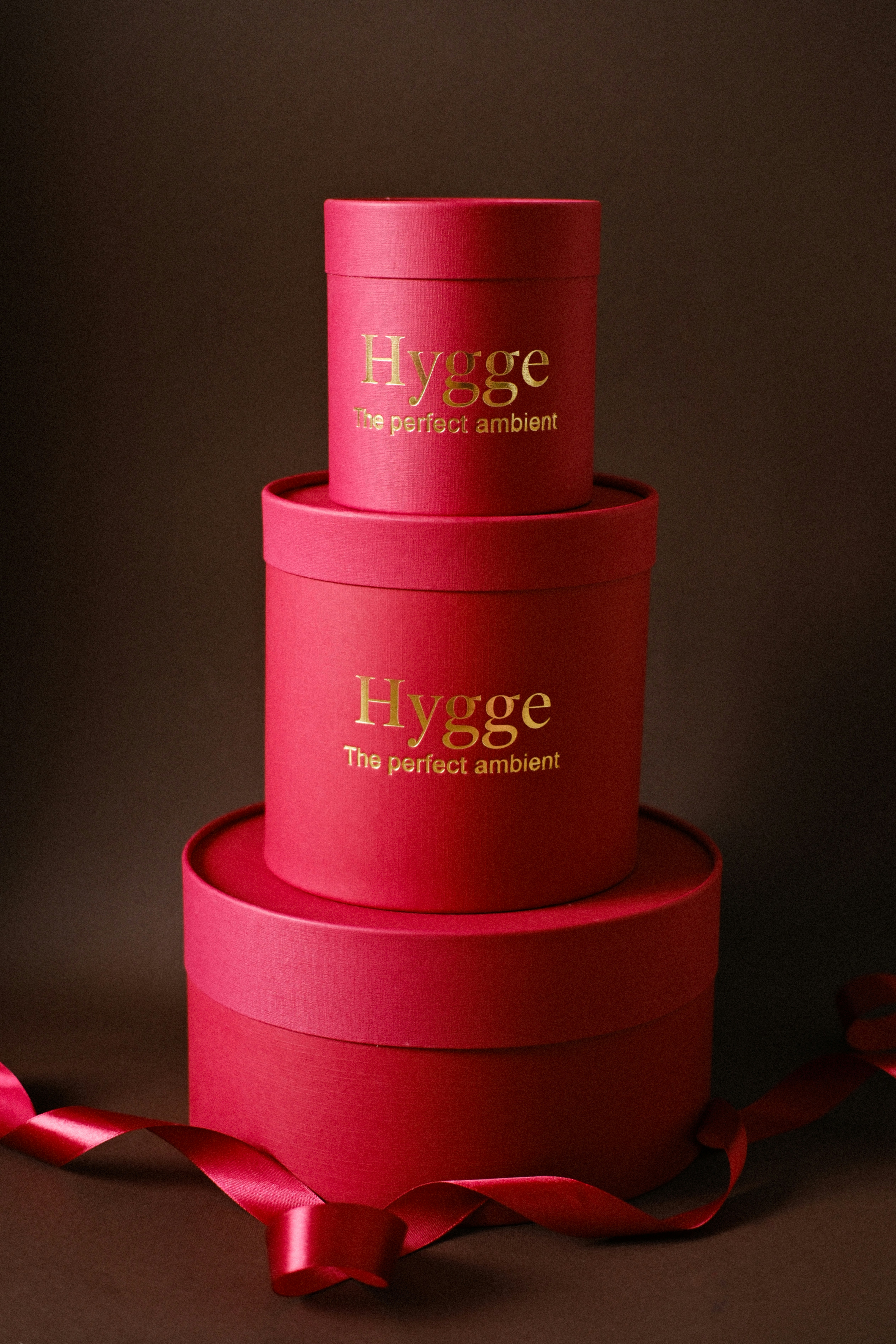 Three stacked red boxes with gold hygge lettering.