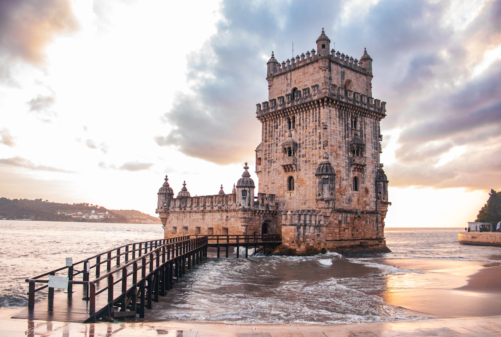 Belém Tower standing beside the Tagus in Lisbon at sunset