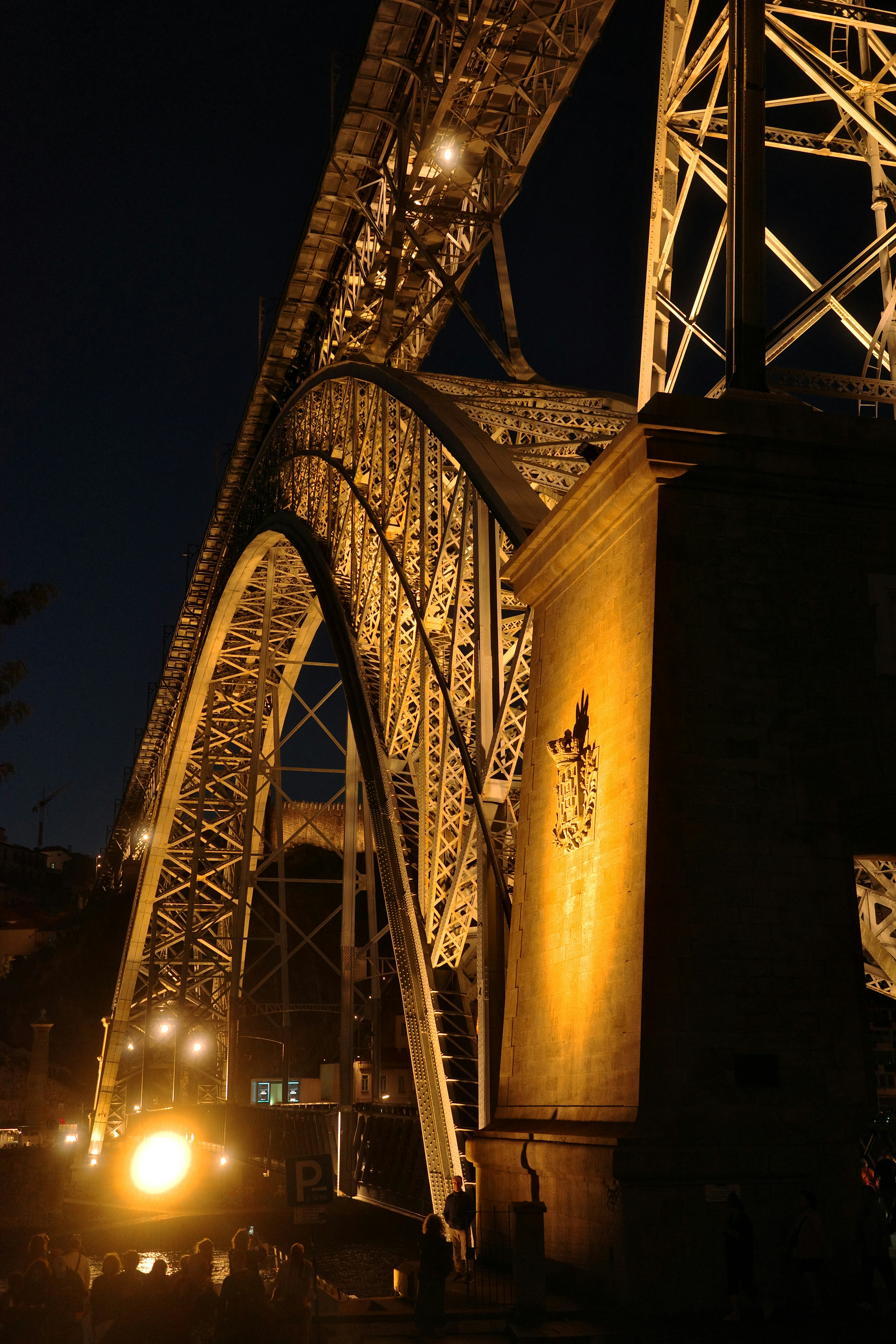 Illuminated steel bridge structure at night