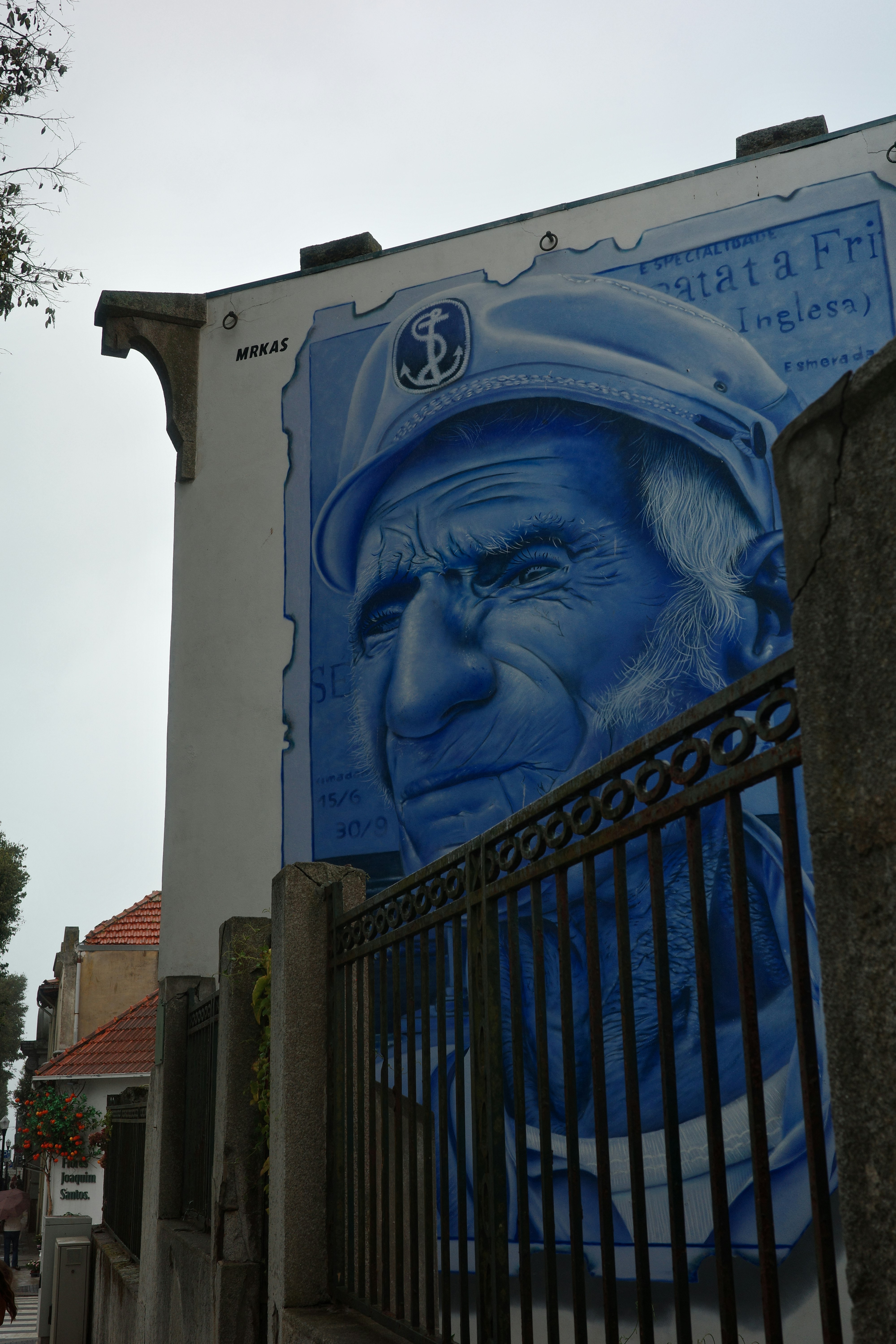 Mural of an old man wearing a blue beret