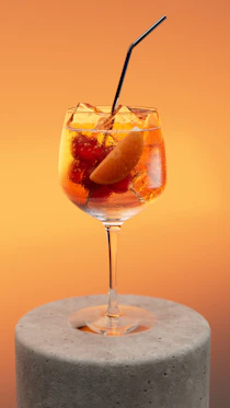 A refreshing cocktail with fruit and ice.