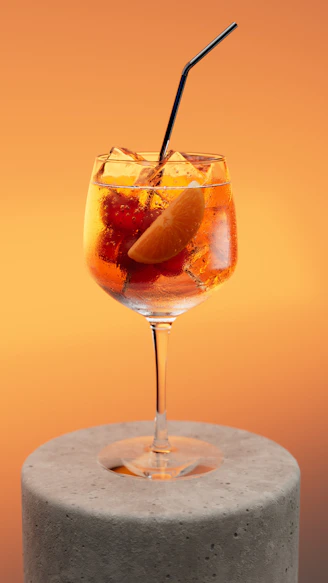 A refreshing cocktail with fruit and ice.