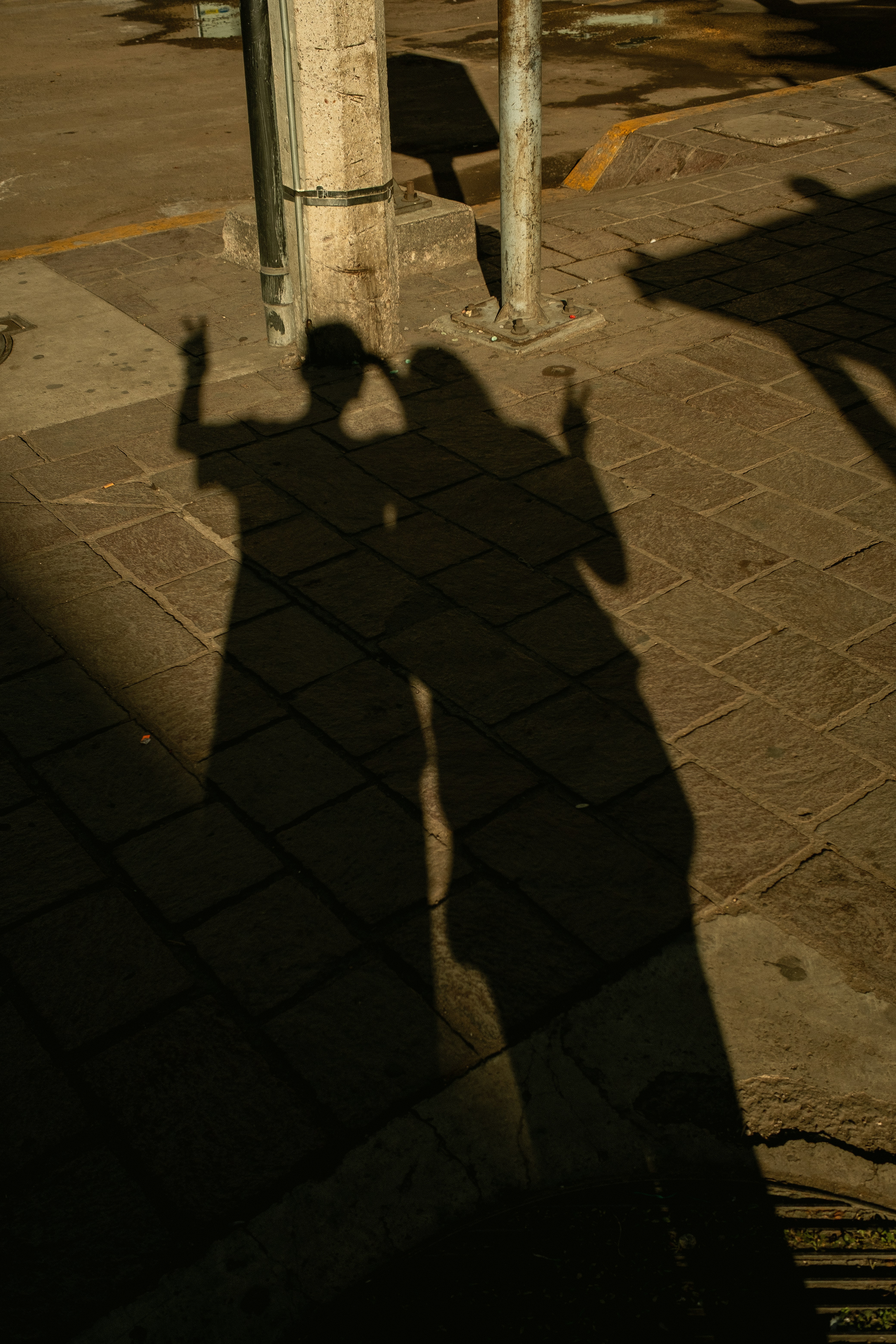 Two people's shadows making peace signs