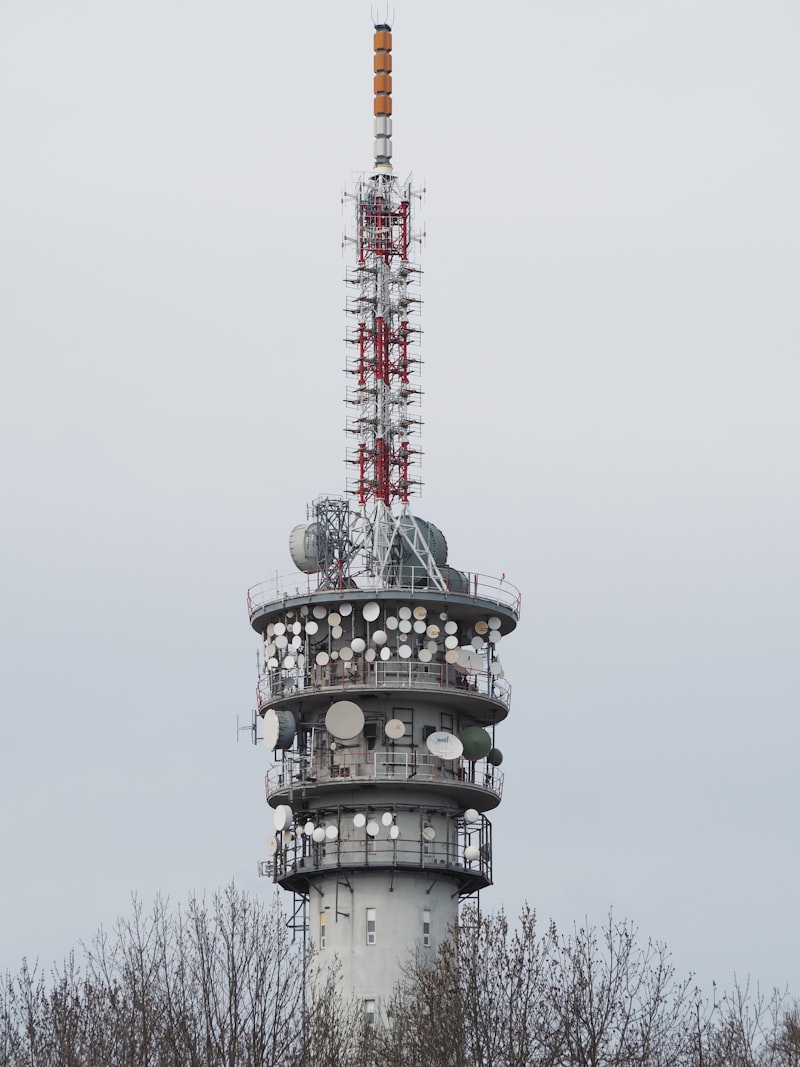A tall broadcasting tower with antennas against sky