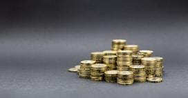 A pile of gold coins on a dark background