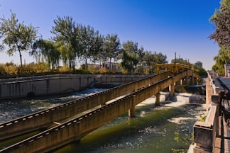 Concrete channels guide water under a clear blue sky.
