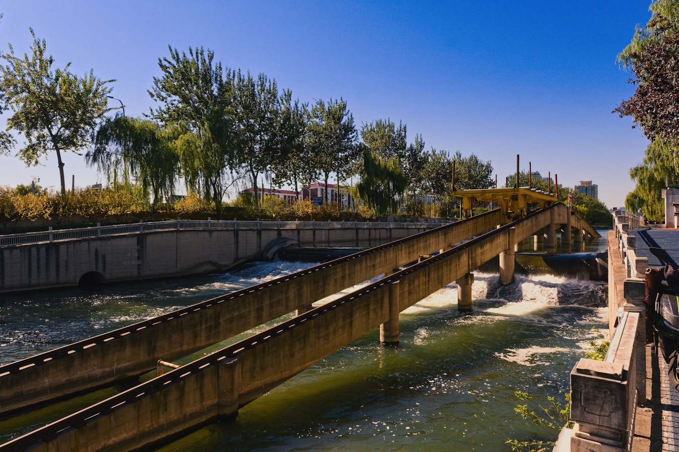 Concrete channels guide water under a clear blue sky.