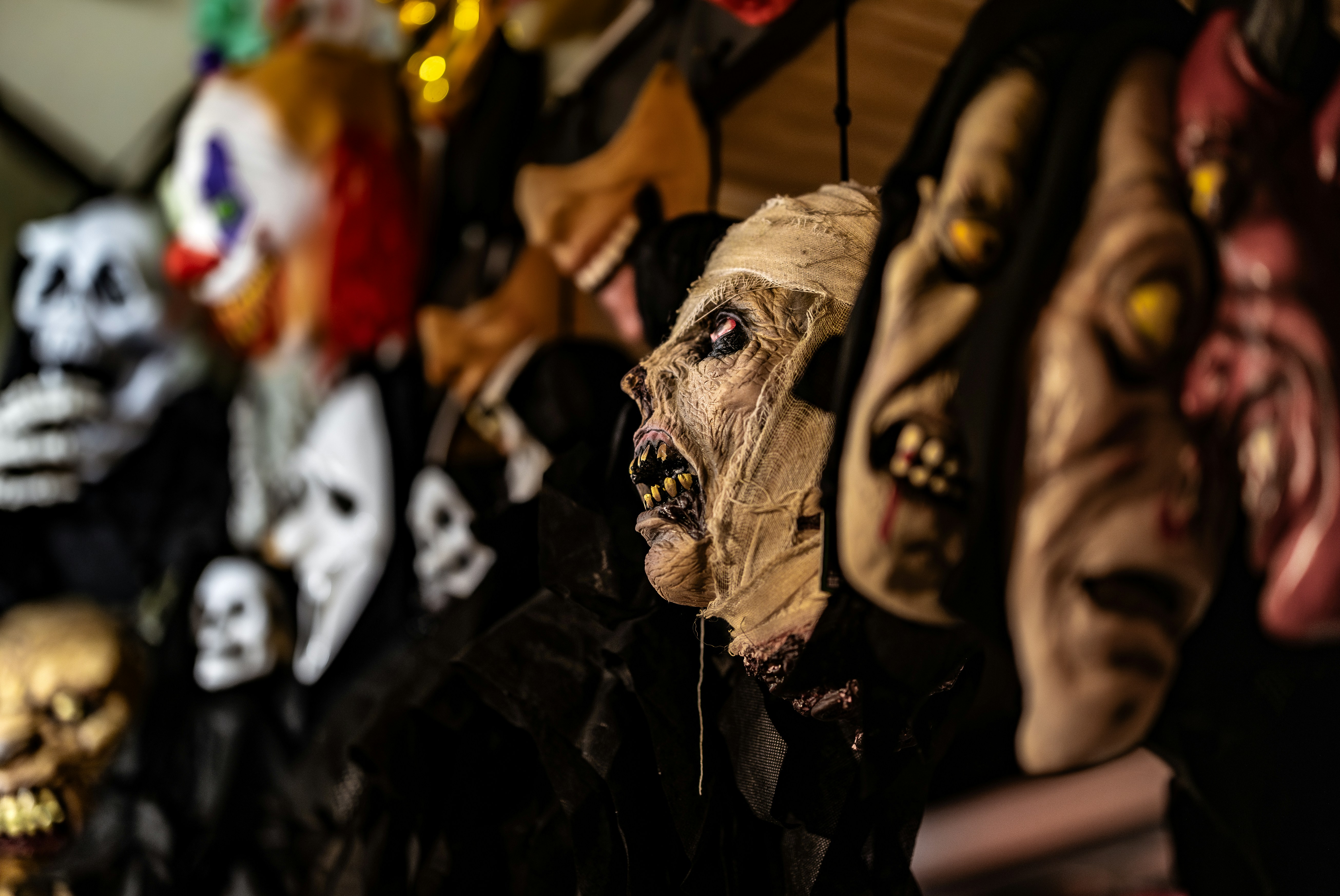 Row of scary halloween masks with clown and zombie